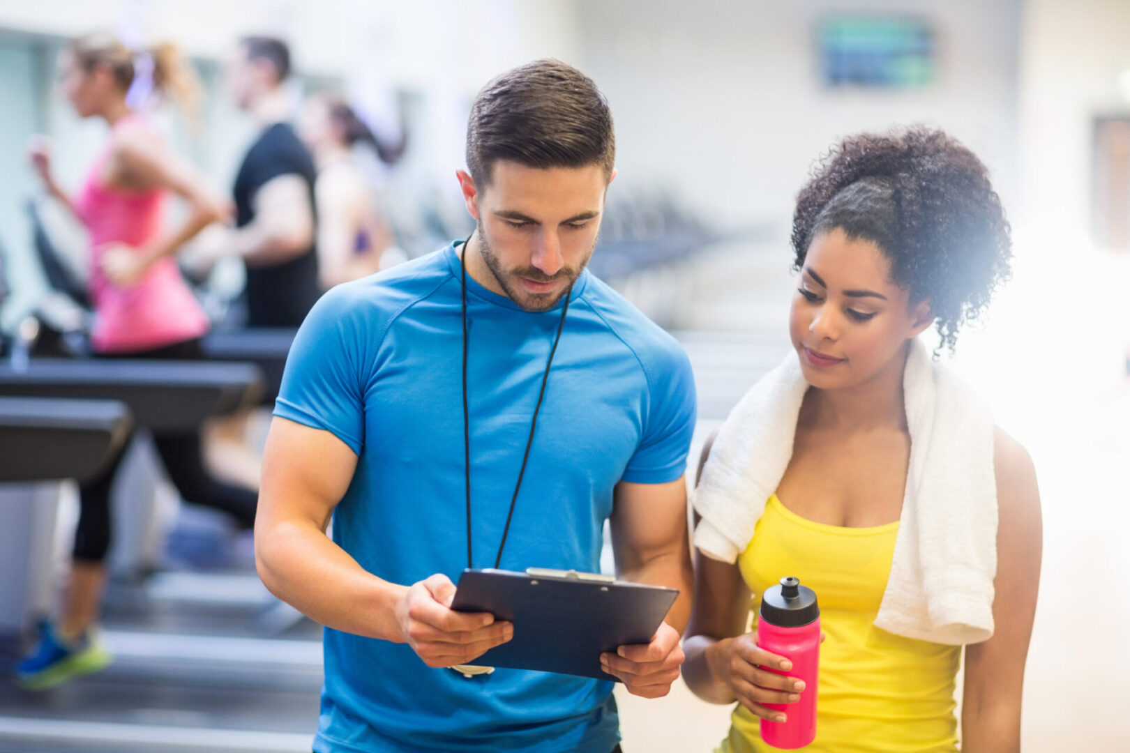 A man and woman looking at a tablet.