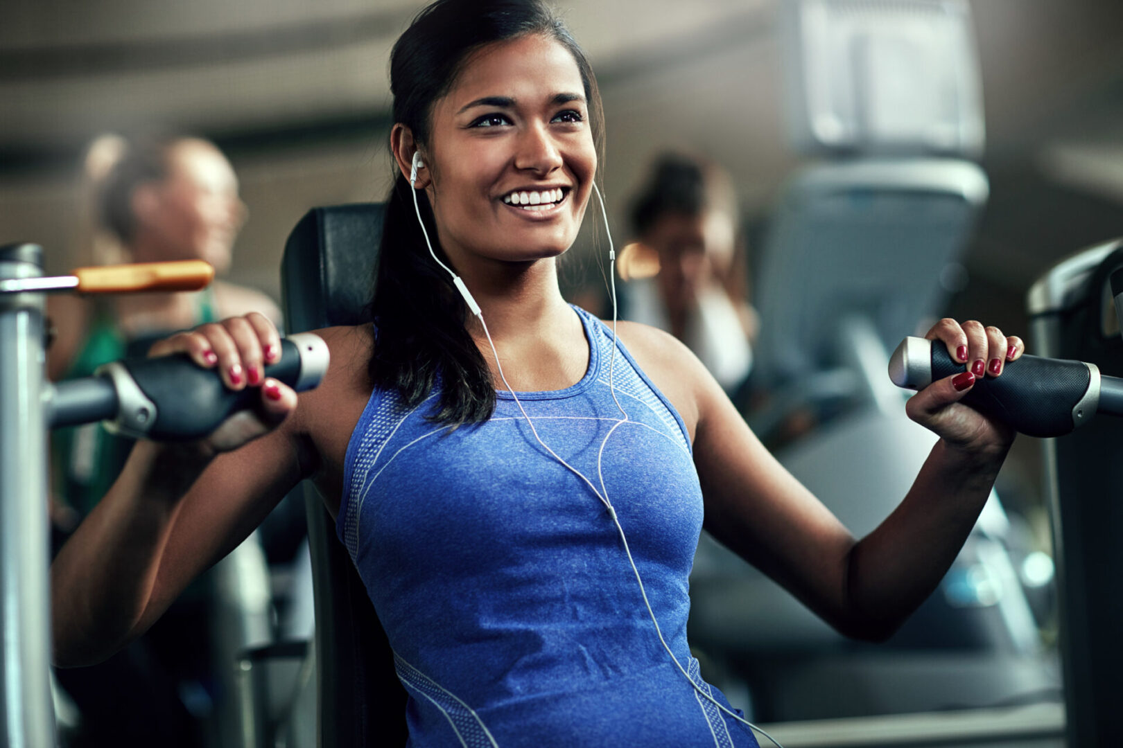 A woman is smiling while listening to music.